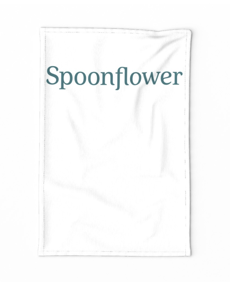 A white tea towel with the word spoonflower in teal