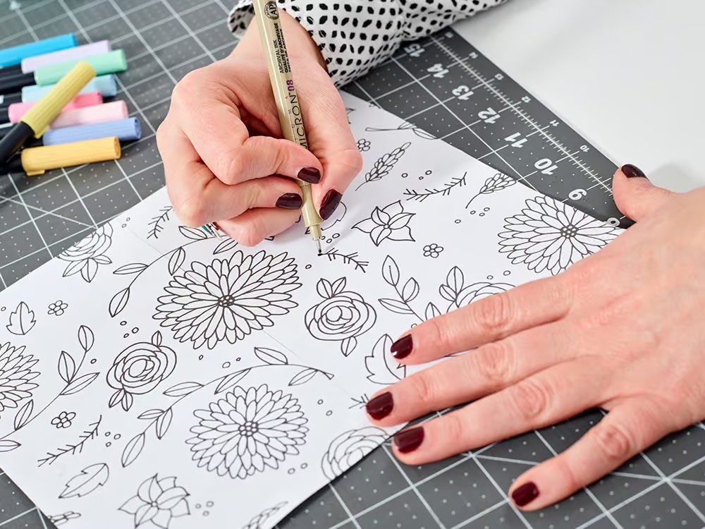 artist fills in the blank space with additional flowers
