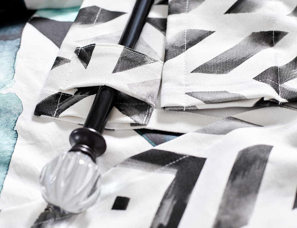 close up photo of back of curtain with black and white watercolor design